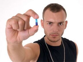 a man is holding a pill to increase potency